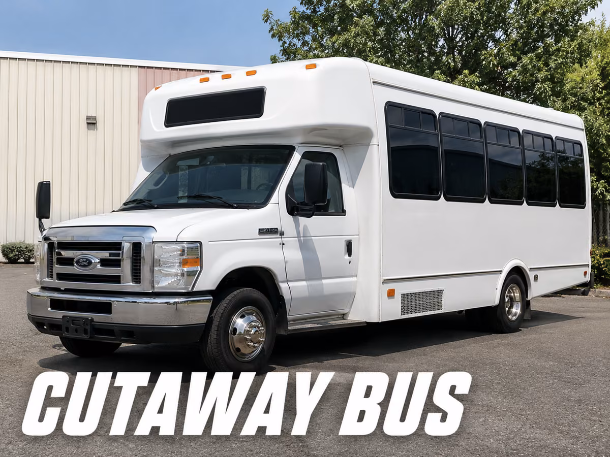 White cutaway bus on a Ford E-450 chassis showing the factory cab joined to a separate bus body