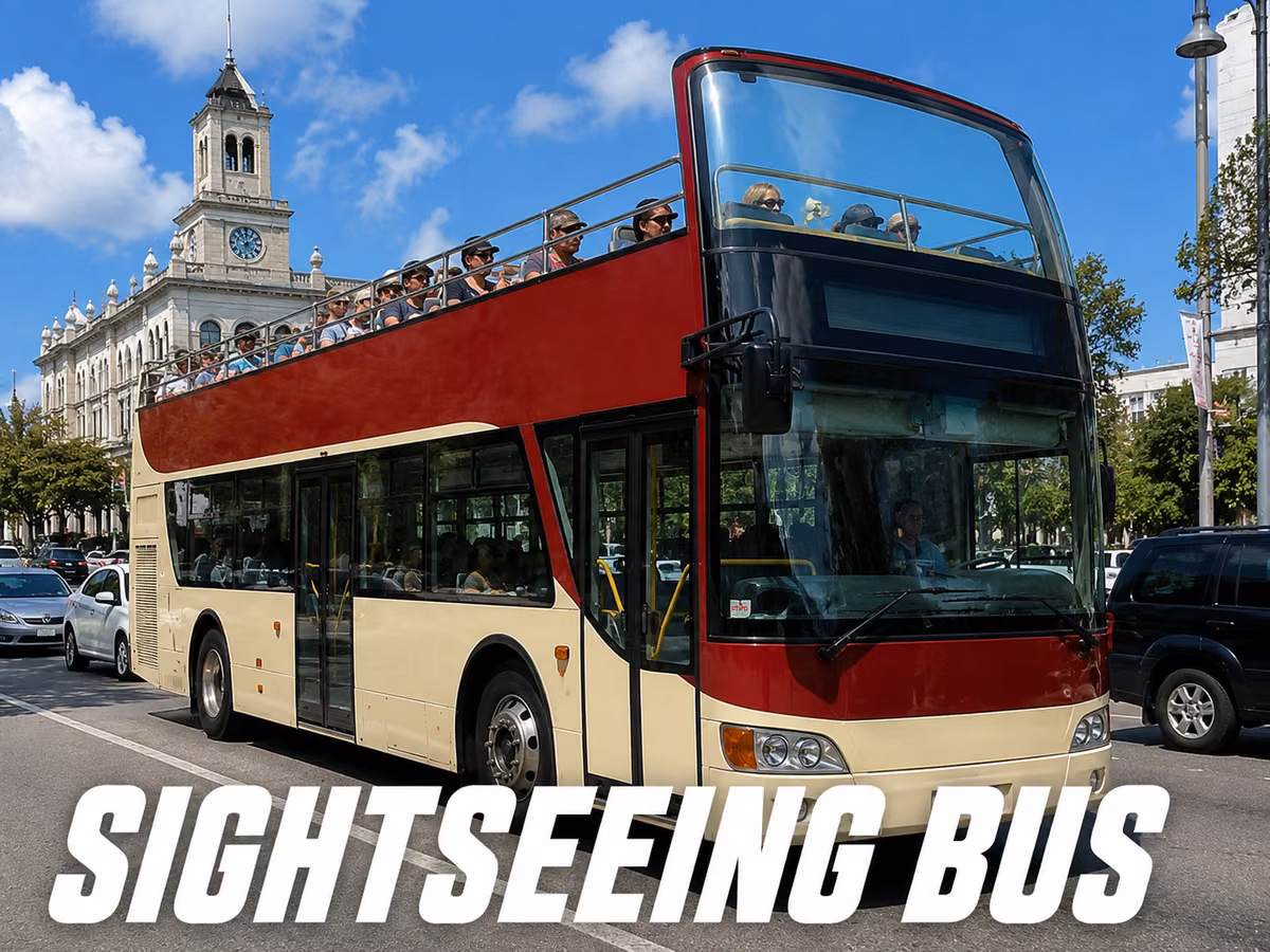 Red and cream open-top double-decker sightseeing bus with passengers on the roofless upper deck