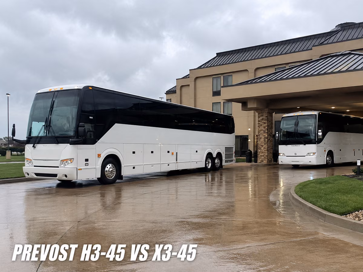 White Prevost coach seen along its full length on a wet apron