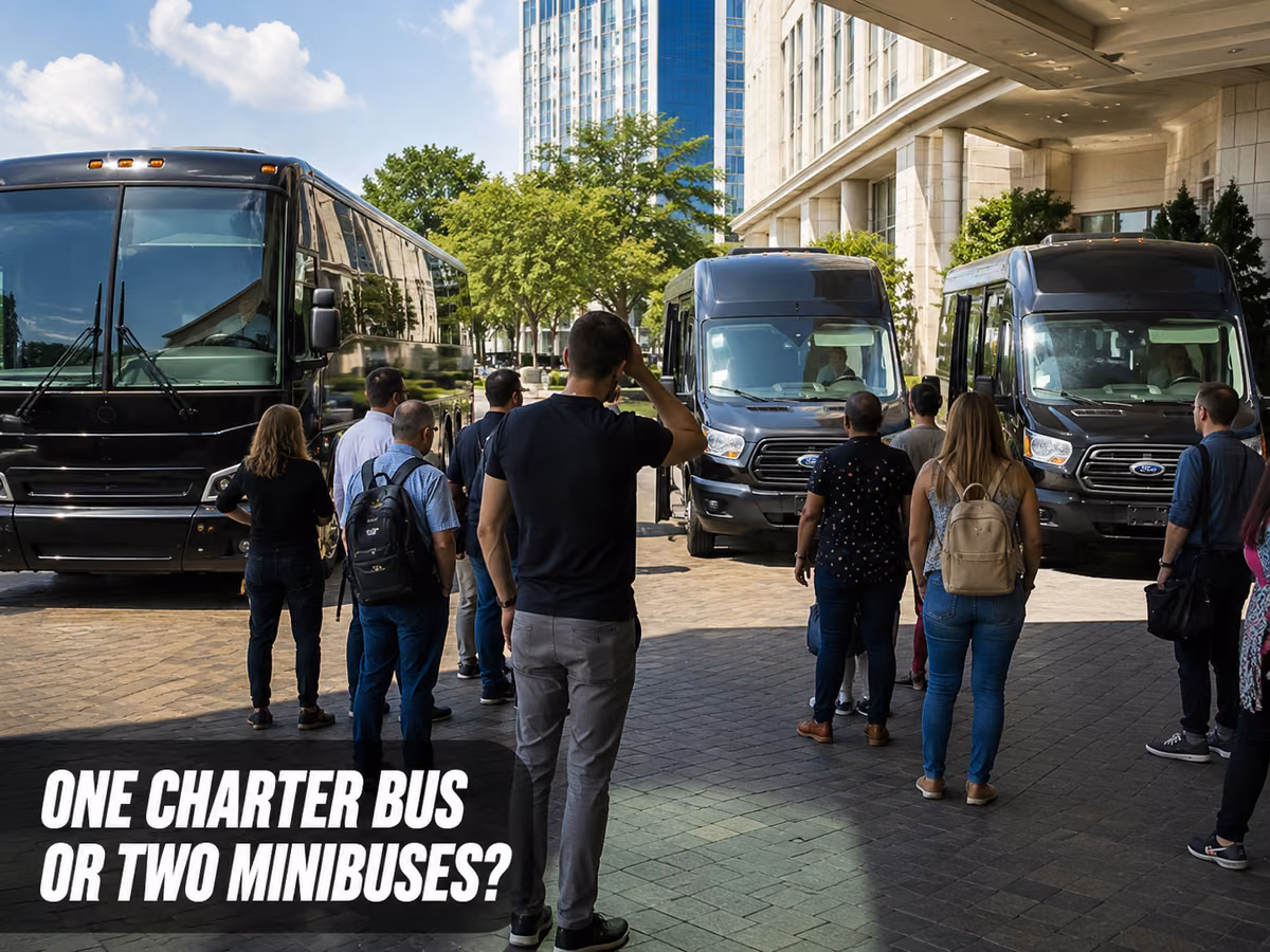 A group of travelers standing beside a pair of minibuses parked at a curb.