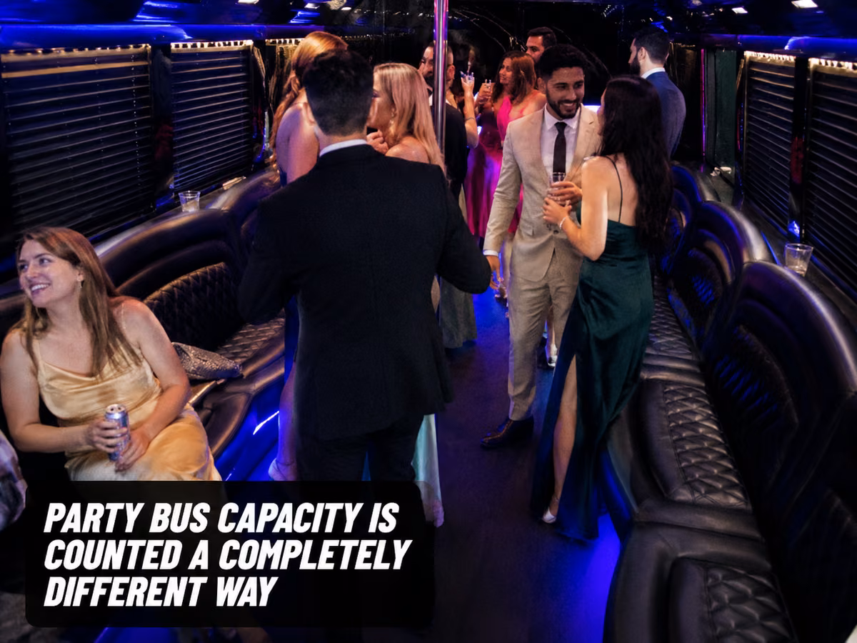 Guests in formalwear standing and socializing inside a party bus with colored perimeter lighting.