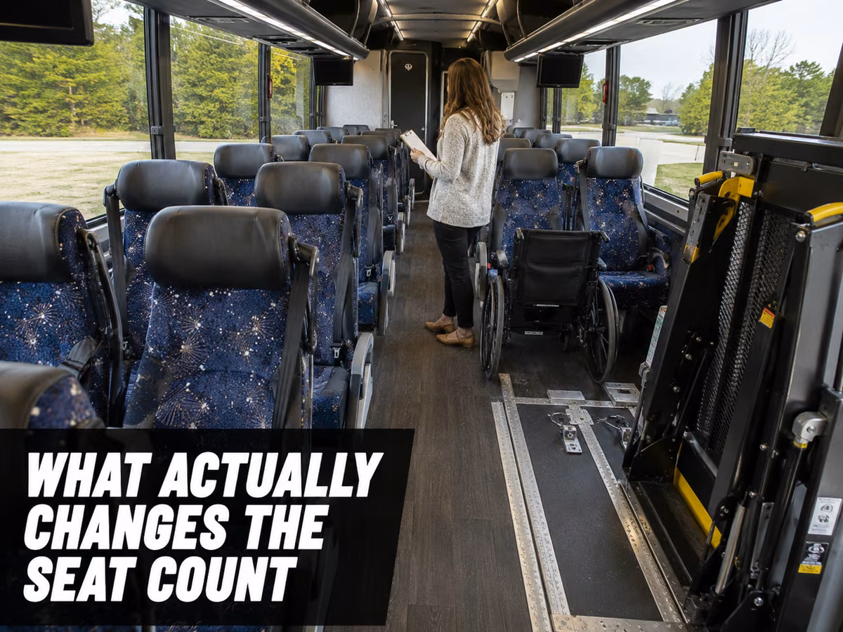 The interior of a coach showing a wheelchair position and tie-down area near the entry.