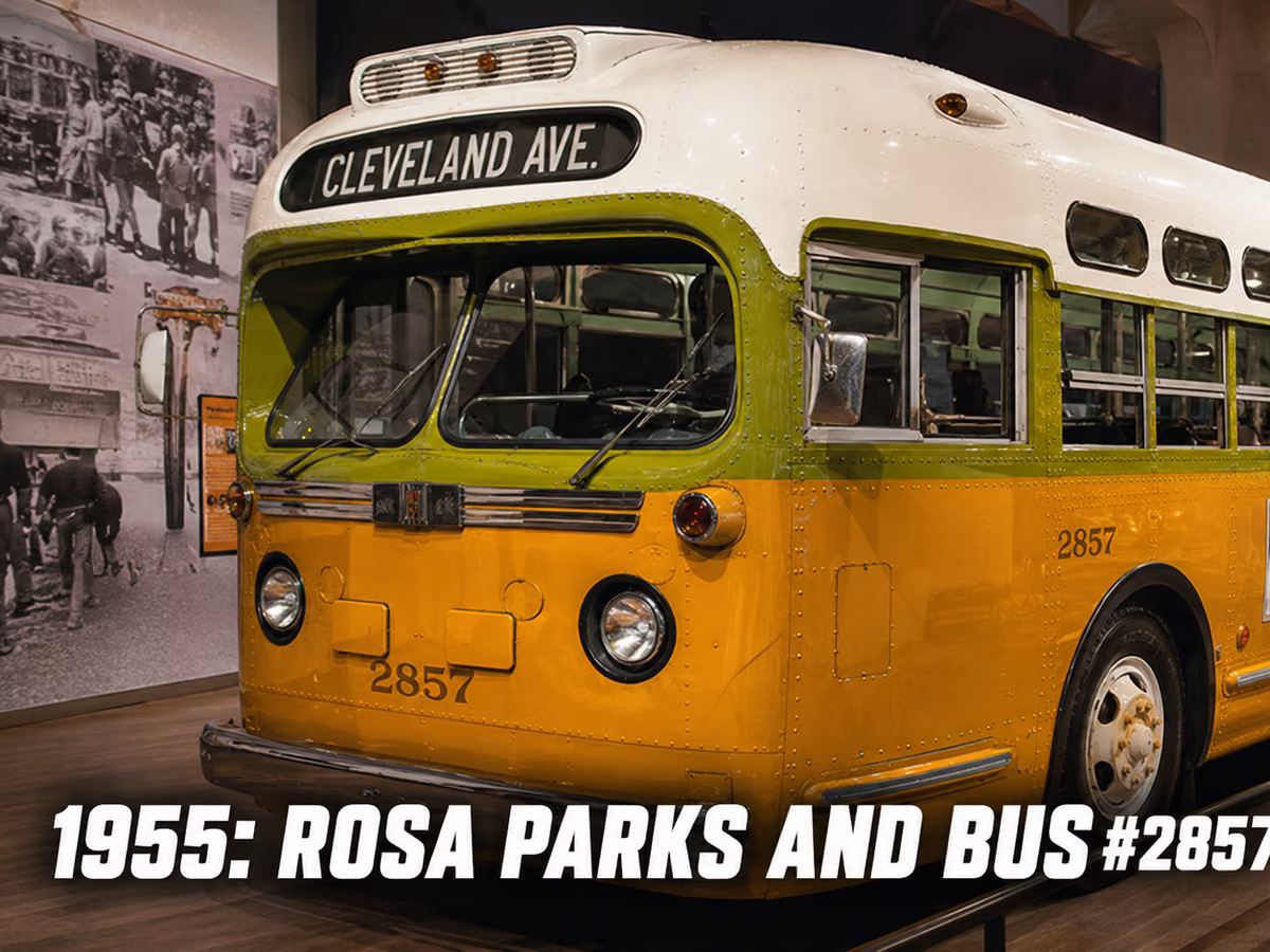 A restored 1940s city transit bus in yellow and green on museum display