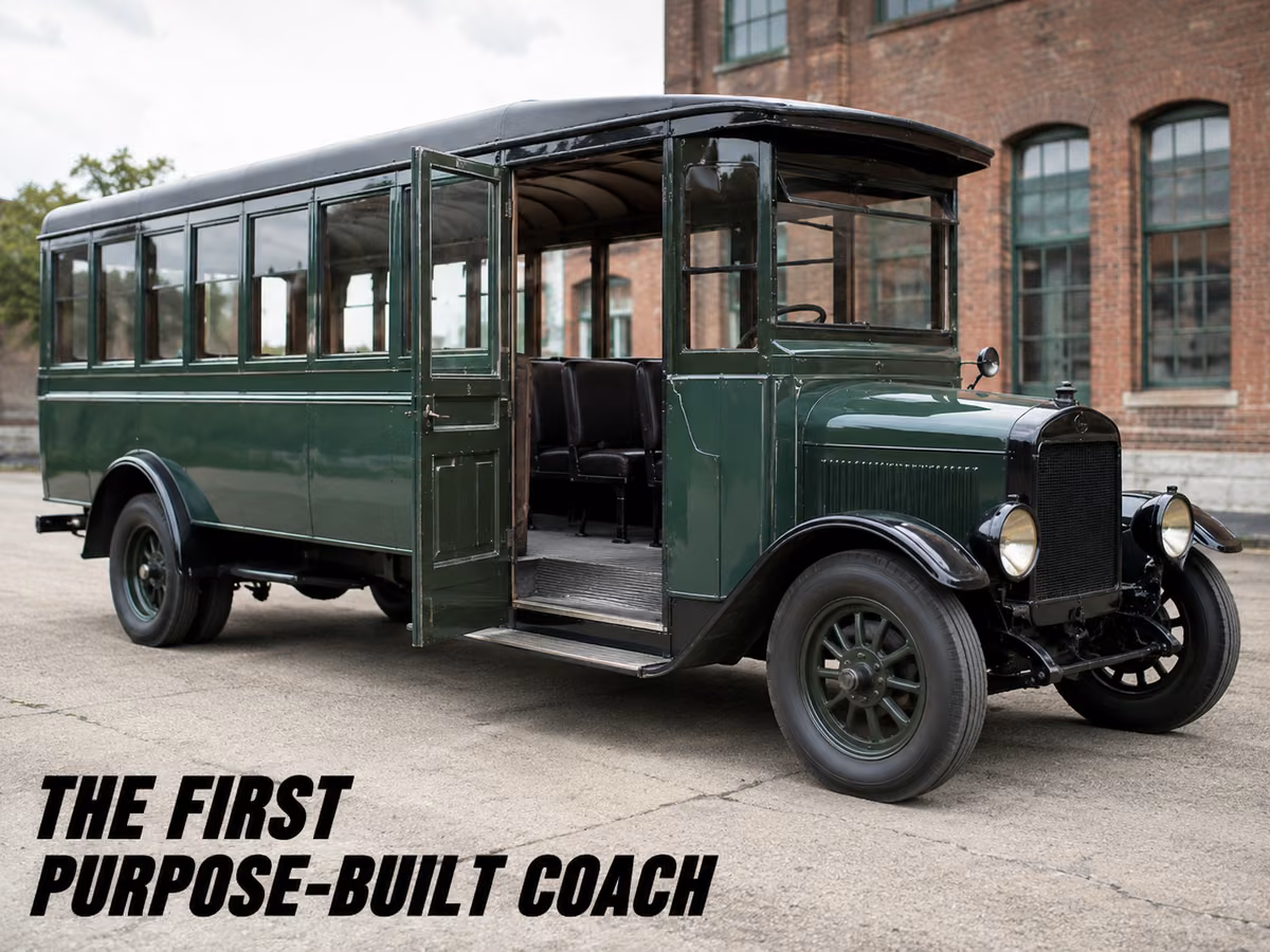 A restored early purpose-built motor coach with a green body and rows of side windows