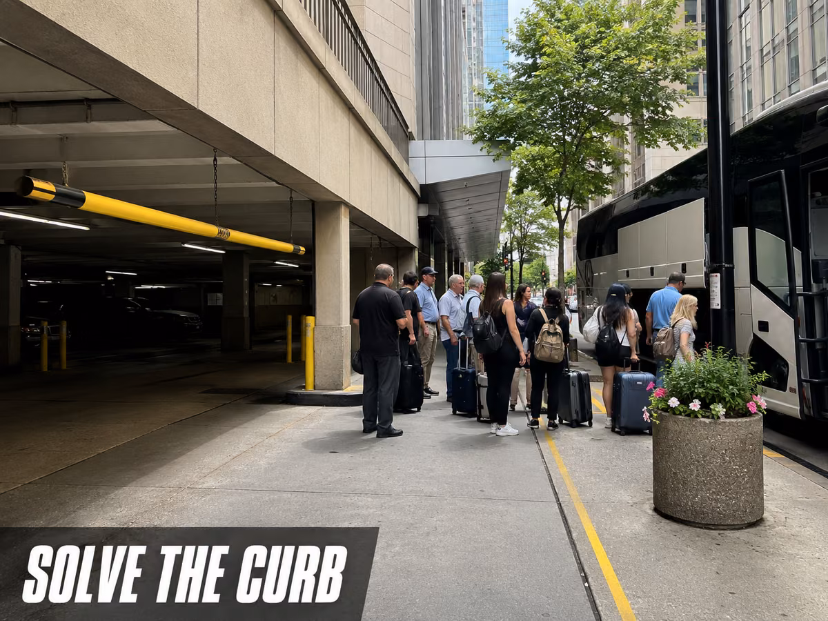 A group of people with luggage boarding a bus at a street-level curb beside a building.