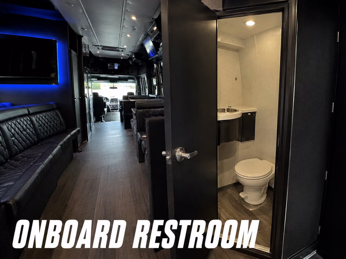 Compact onboard restroom with a toilet inside a party bus