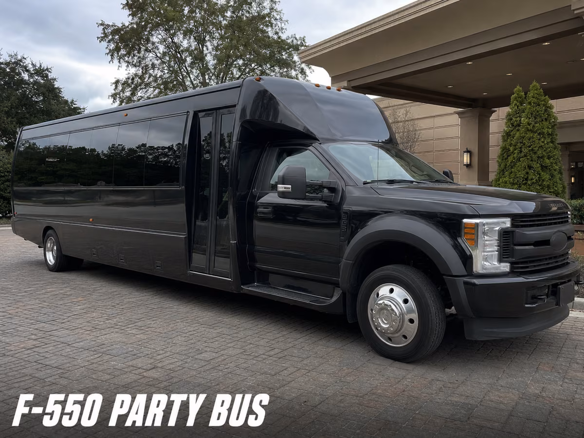 Black Ford F-550 party bus parked under a covered portico entrance