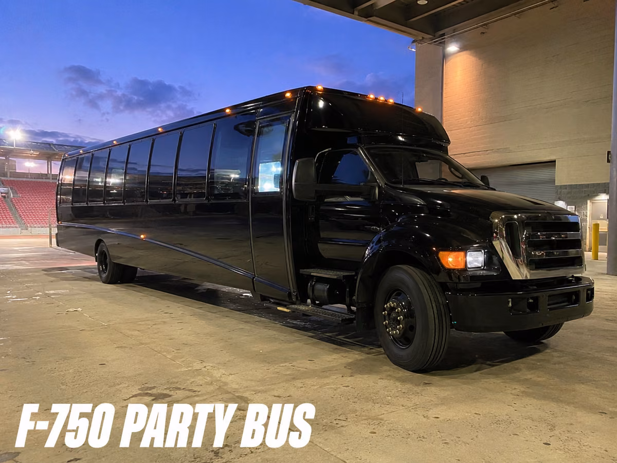 Black Ford F-750 party bus parked outside a building at dusk