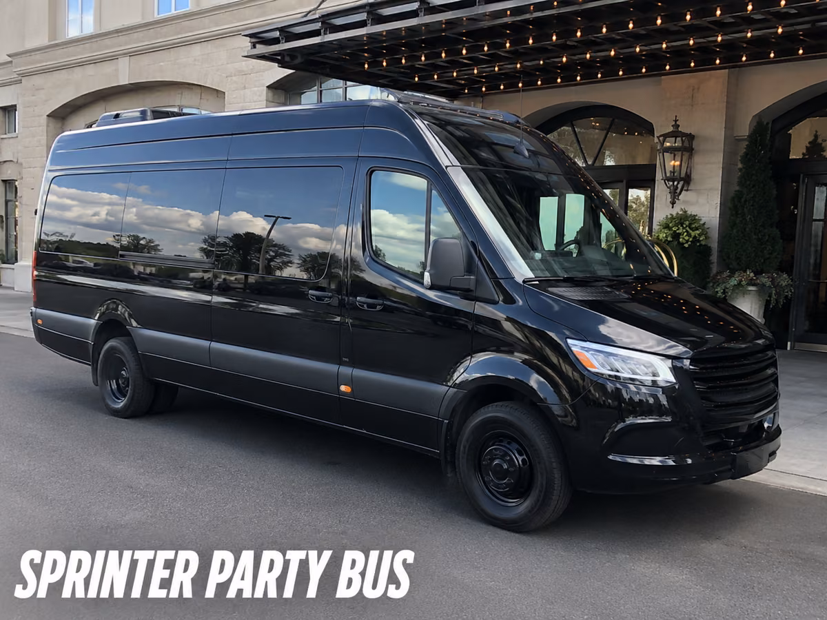 Black Mercedes-Benz Sprinter party bus parked outside a lit building entrance
